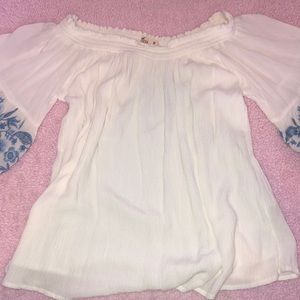 Over the shoulder white embroidered top